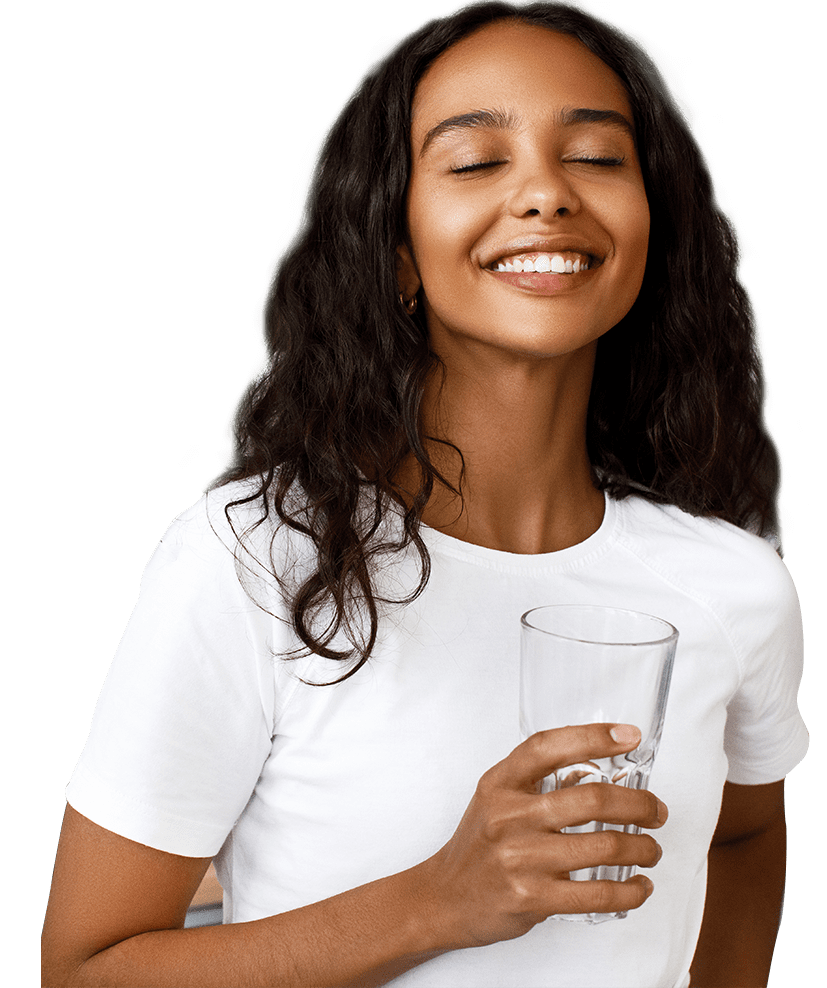 Happy client of EcoWater of Atlanta enjoying a glass of water beautiful woman drinking a fresh glass of water